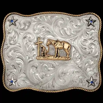 A custom western belt buckle featuring a praying cowgirl figure 